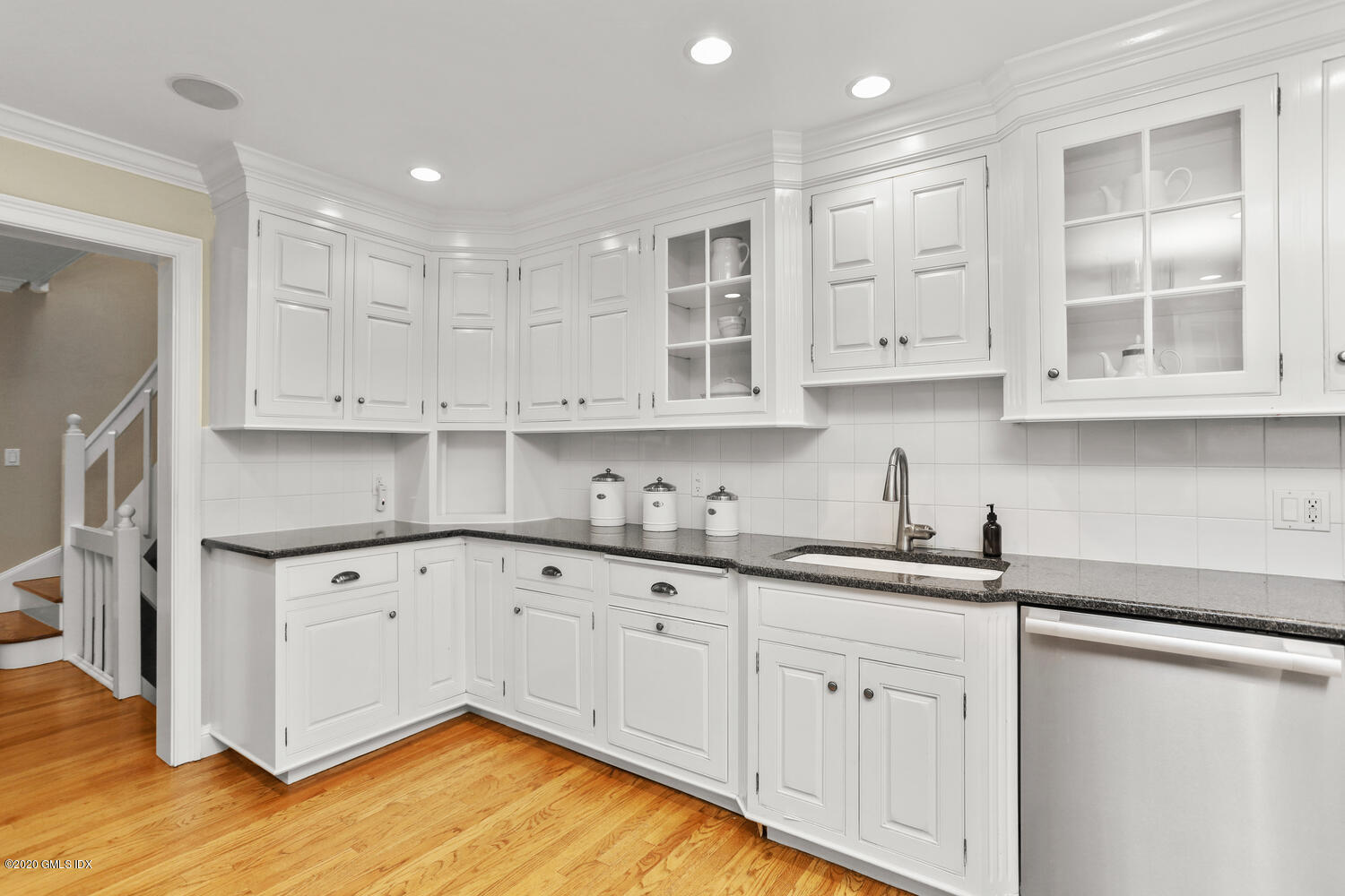 101 Lewis Street, Unit F Greenwich, CT 06830 - Photo 11 of 27 a kitchen with granite countertop white cabinets and a sink