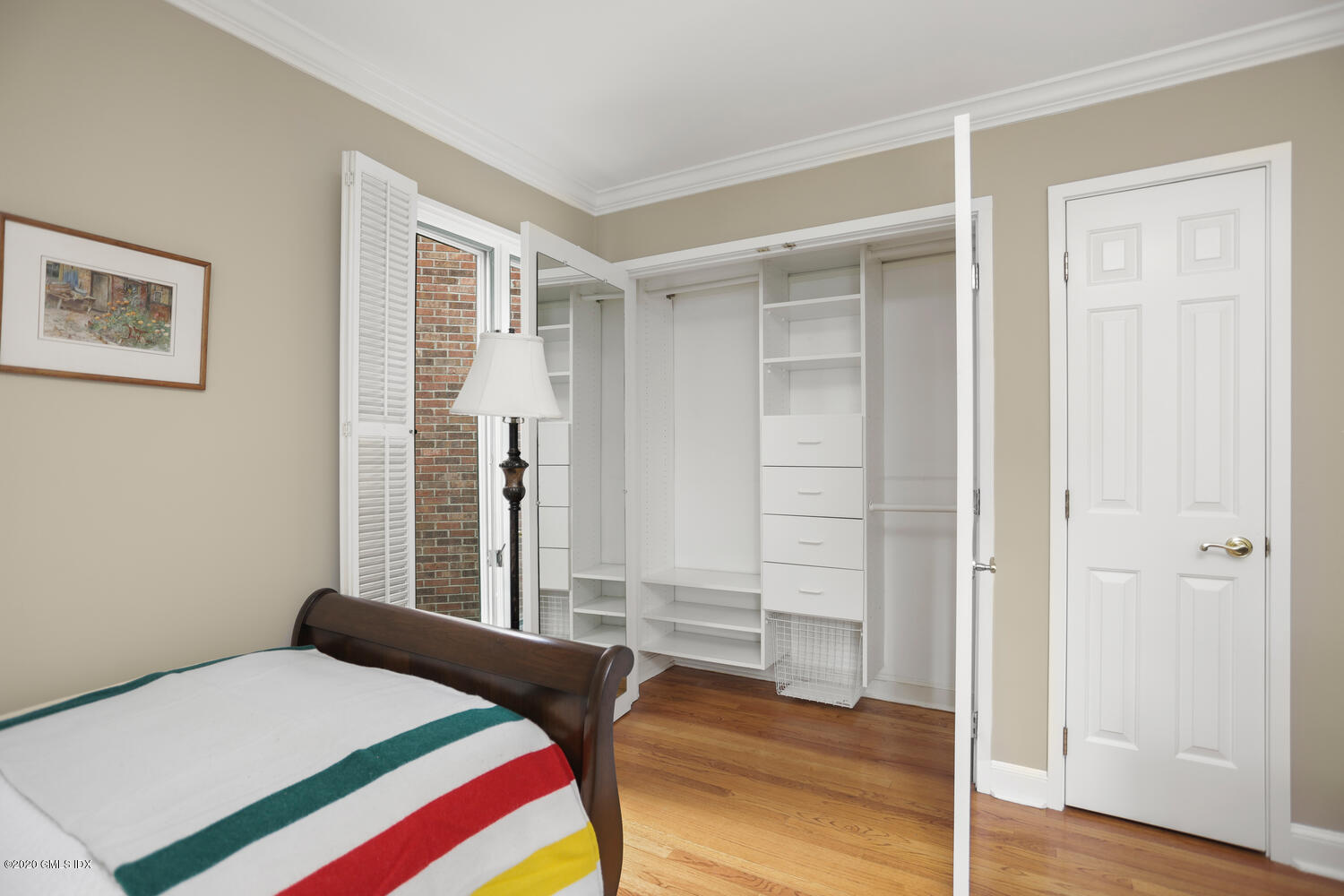 101 Lewis Street, Unit F Greenwich, CT 06830 - Photo 17 of 27 a bedroom with a bed and wooden floor