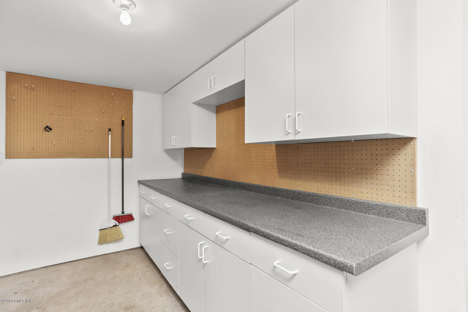 101 Lewis Street, Unit F Greenwich, CT 06830 - Photo 23 of 27 a kitchen with a sink and cabinets
