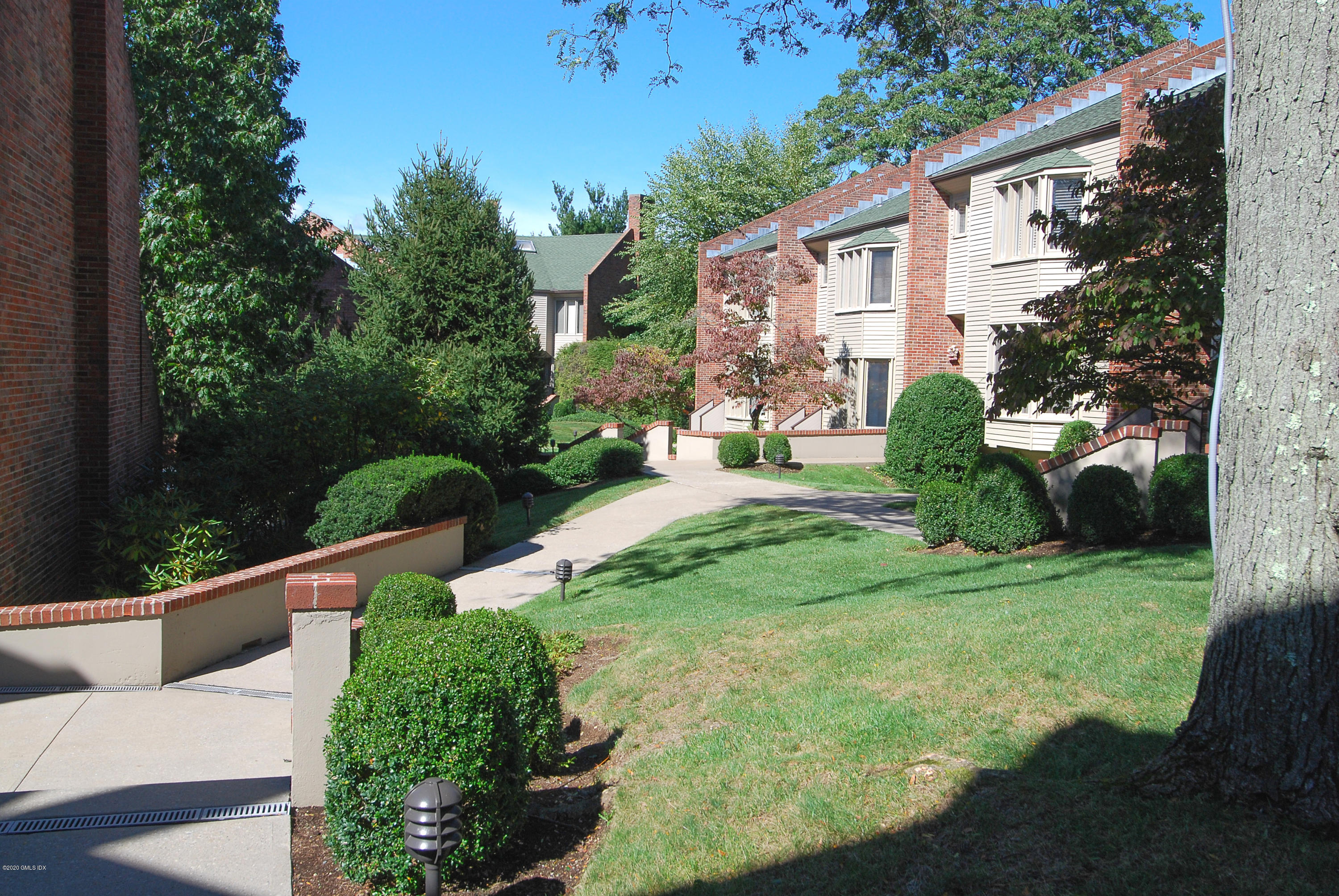 101 Lewis Street, Unit F Greenwich, CT 06830 - Photo 26 of 27 a view of a house with backyard sitting area and garden