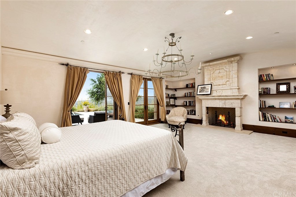 82 Golden Eagle Irvine, CA 92603 - Photo 17 of 40 a bedroom with a bed and a fireplace