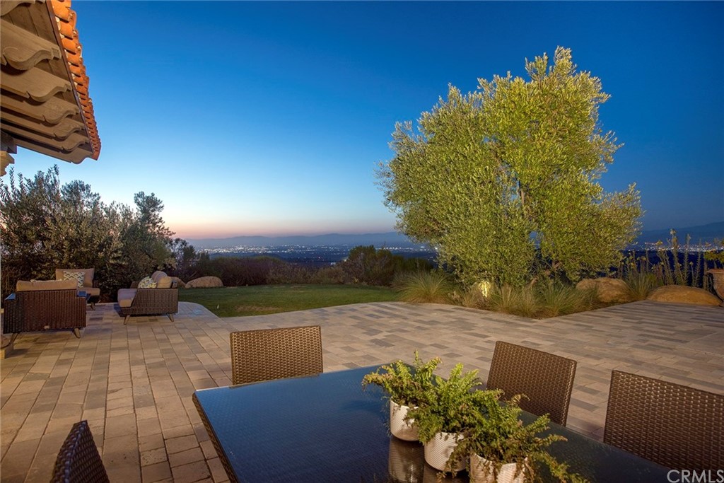 82 Golden Eagle Irvine, CA 92603 - Photo 27 of 40 a view of a patio with couches and table and chairs and potted plants