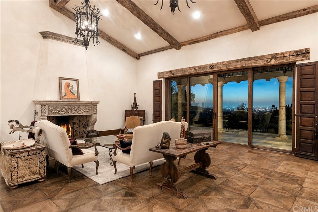 82 Golden Eagle Irvine, CA 92603 - Photo 5 of 40 a living room with furniture gym equipment and a fireplace