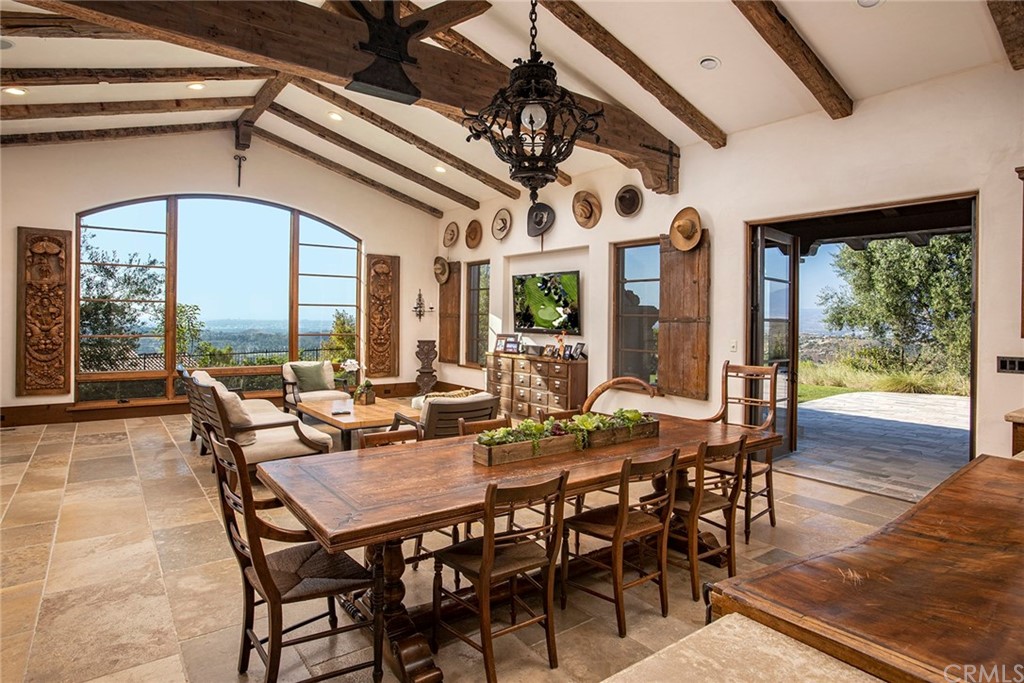 82 Golden Eagle Irvine, CA 92603 - Photo 6 of 40 a view of a dining room with furniture large windows and wooden floor