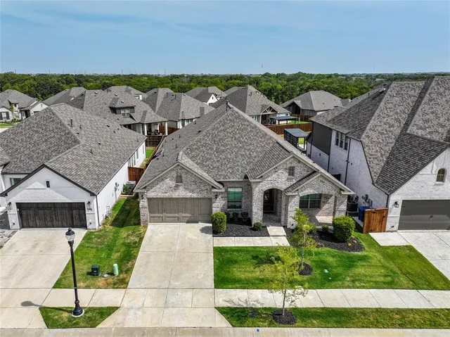a aerial view of a house with a yard