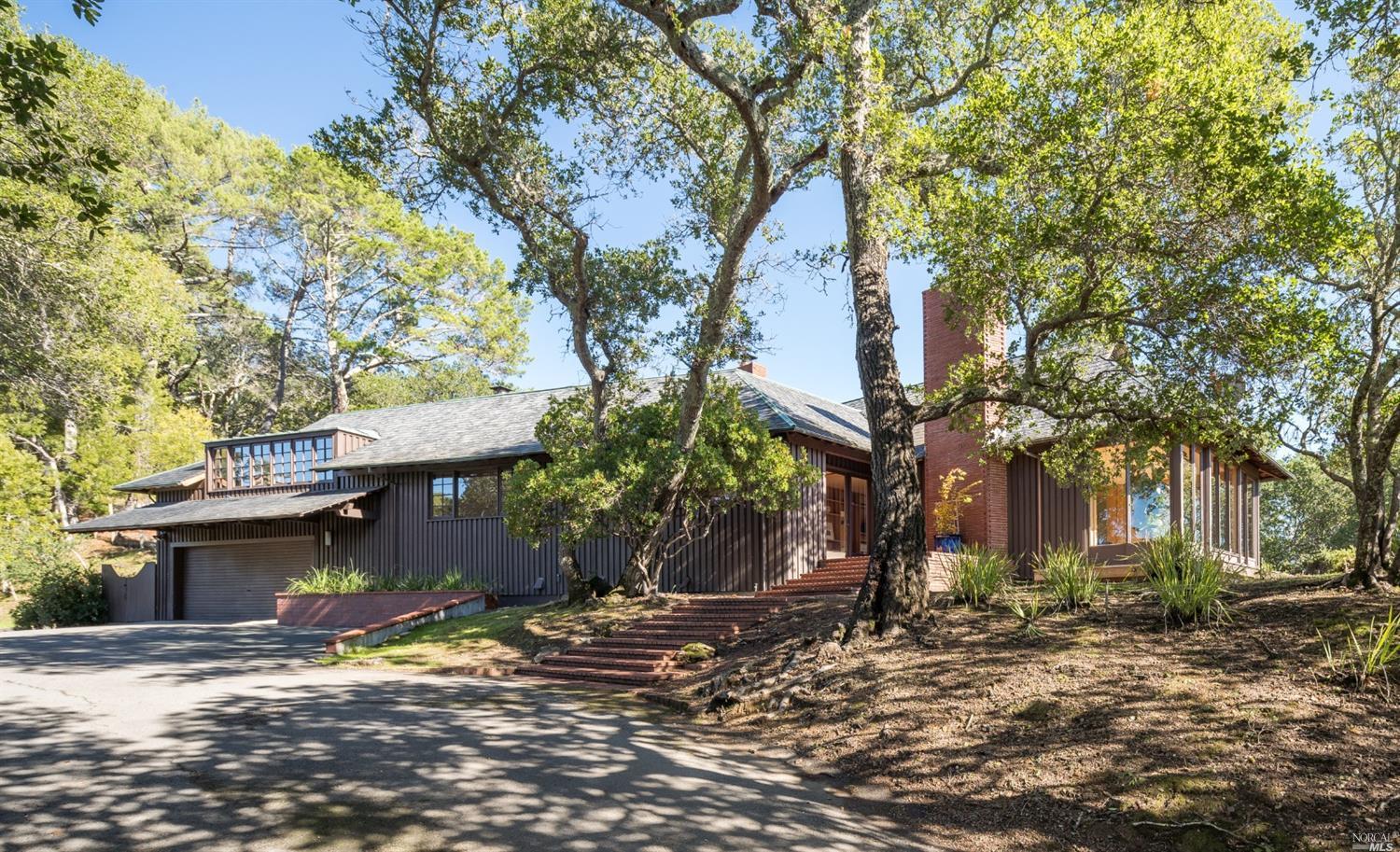 a view of a house with a tree next to a road