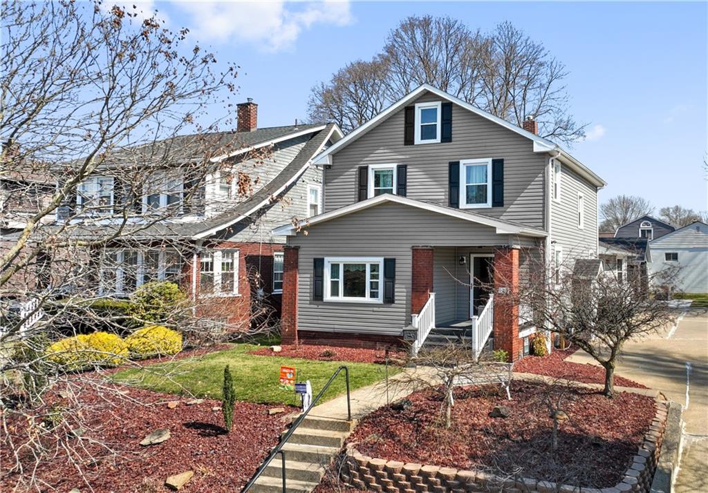 a front view of a house with garden