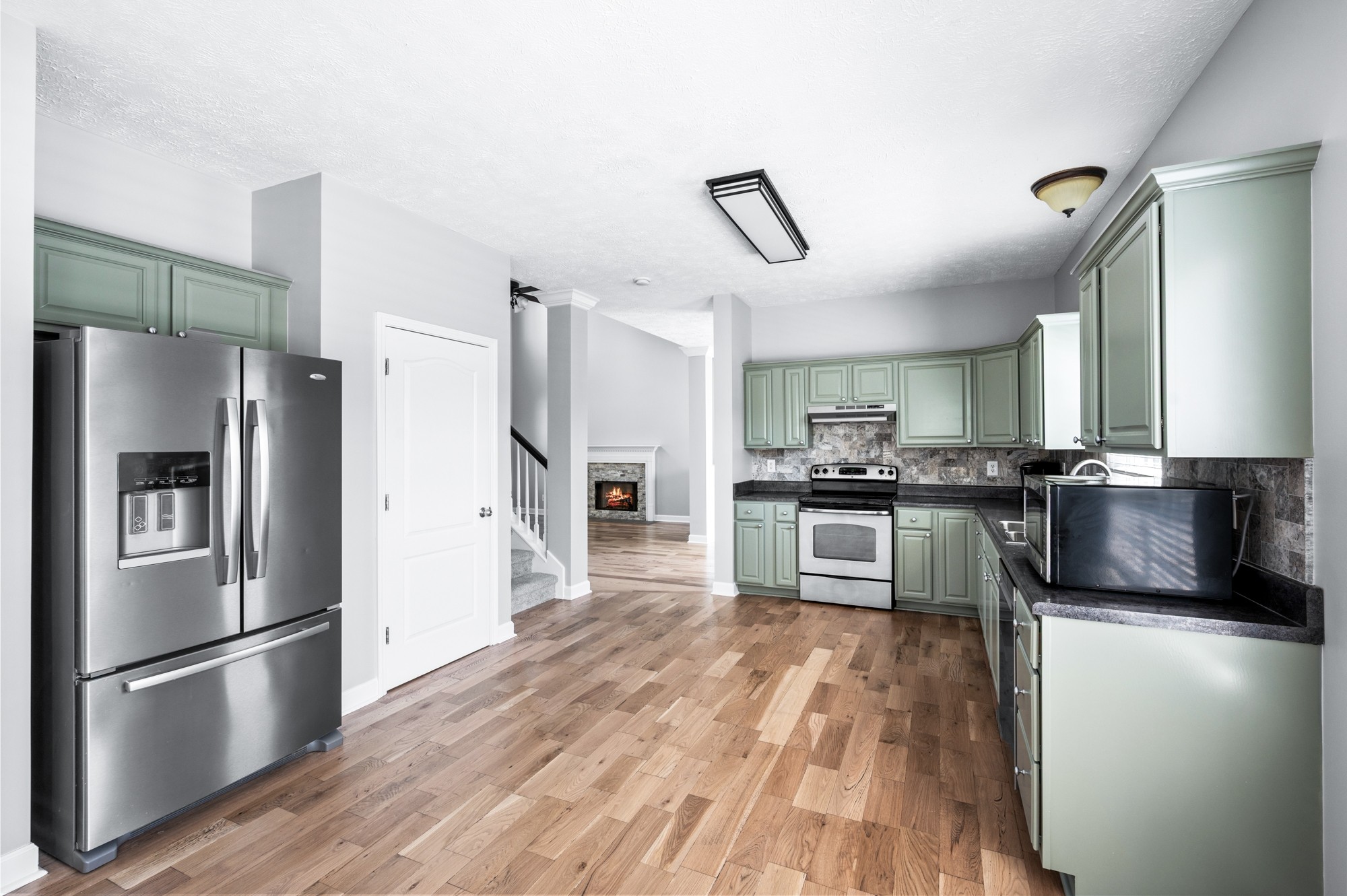 7203 Blue Ridge Drive Fairview, TN 37062 - Photo 20 of 65 a kitchen with a refrigerator cabinets and wooden floor