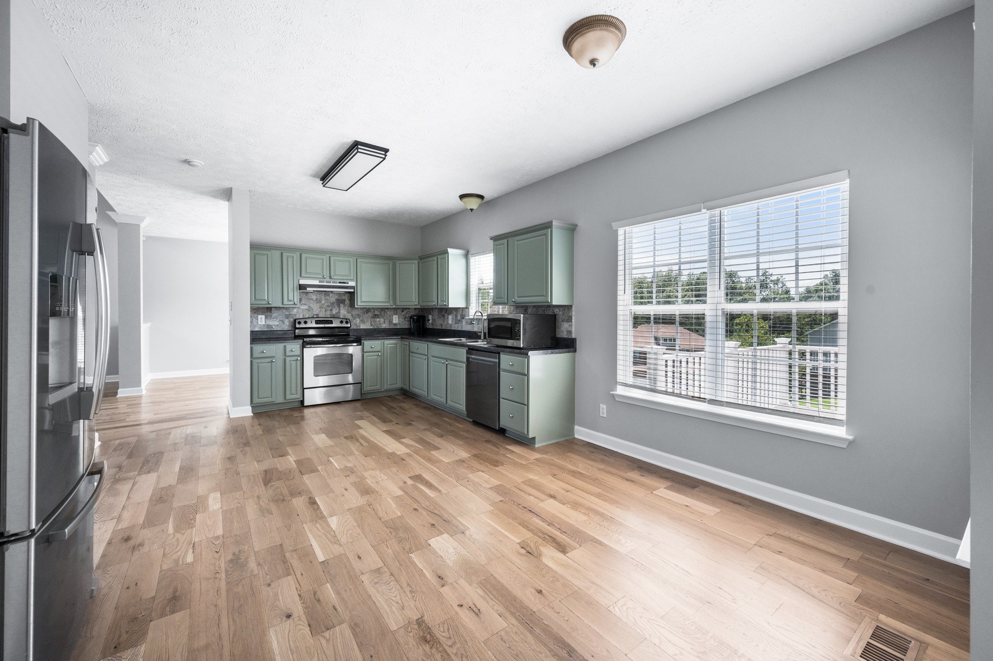 7203 Blue Ridge Drive Fairview, TN 37062 - Photo 24 of 65 a kitchen with stainless steel appliances granite countertop a refrigerator and a stove top oven