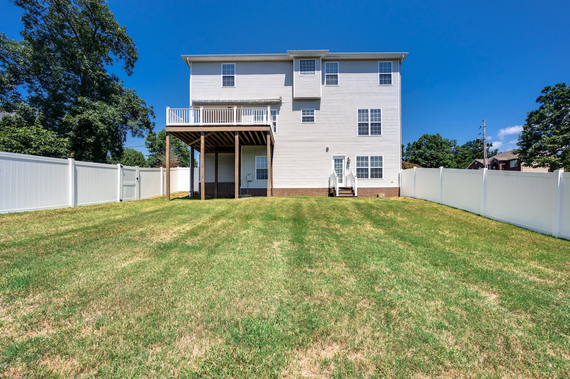 7203 Blue Ridge Drive Fairview, TN 37062 - Photo 54 of 65 a view of a white house with a big yard and potted plants
