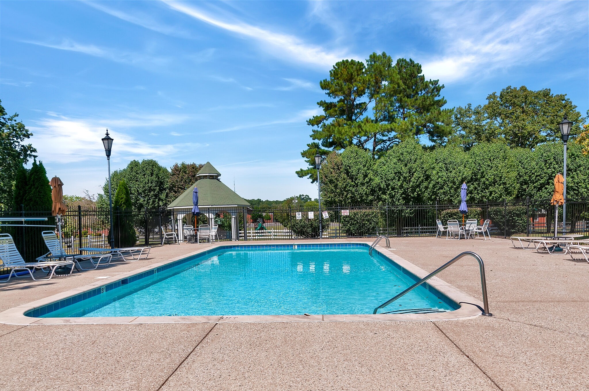 7203 Blue Ridge Drive Fairview, TN 37062 - Photo 60 of 65 a view of a swimming pool with lawn chairs under an umbrella