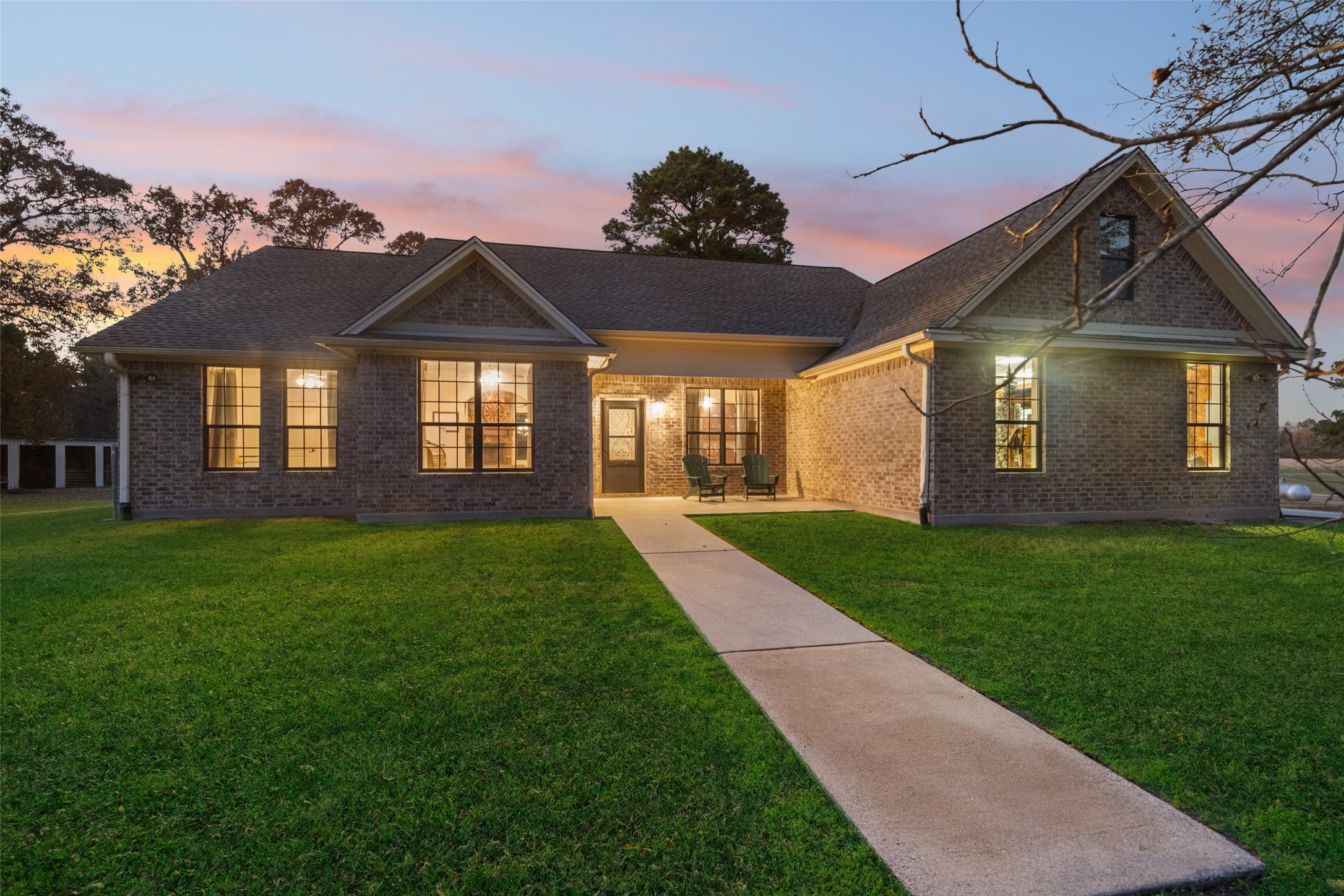 a front view of a house with a garden