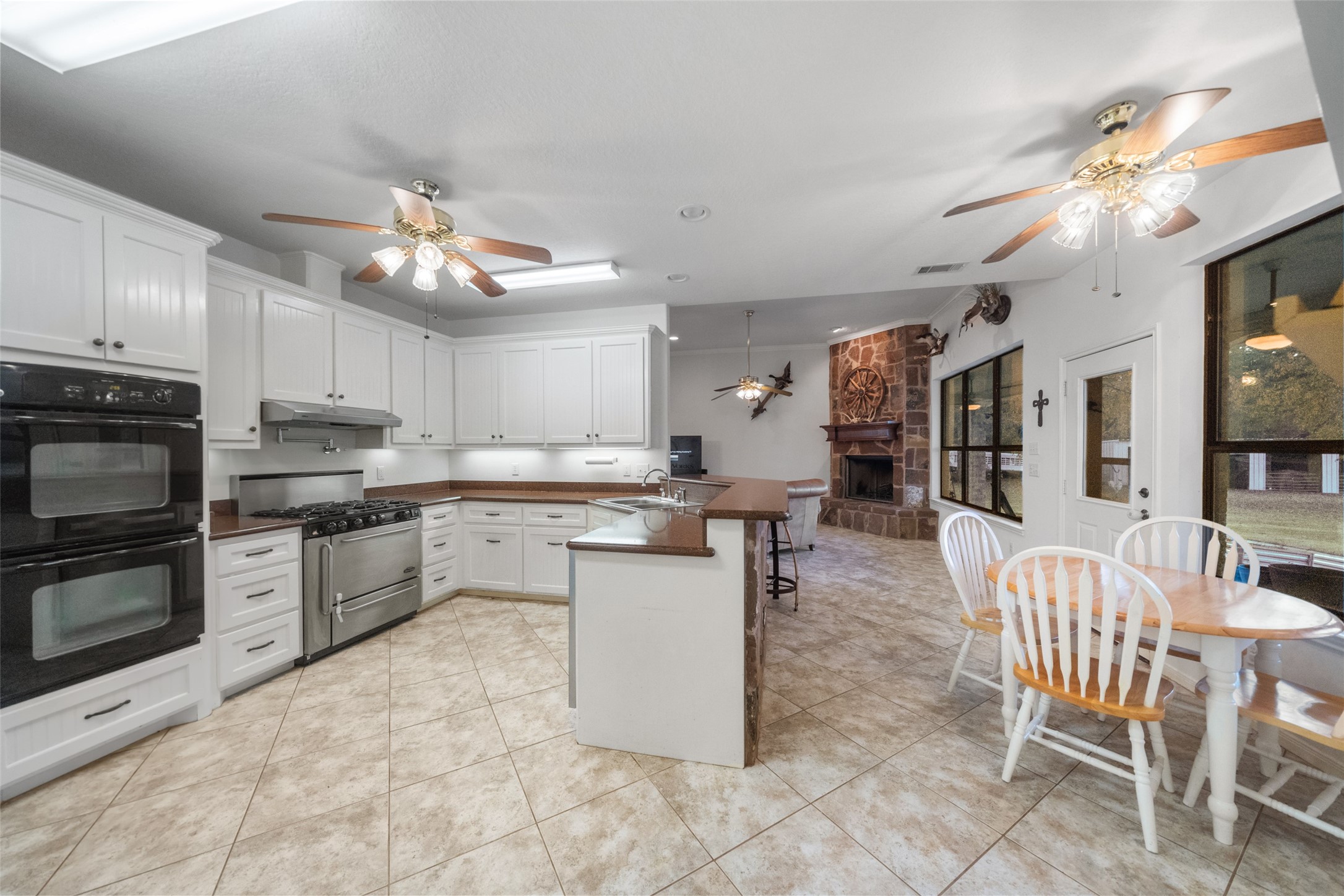 394 Farm To Market 230 Trinity, TX 75862 - Photo 15 of 34 a kitchen with stainless steel appliances a stove a sink a oven a dining table and chairs
