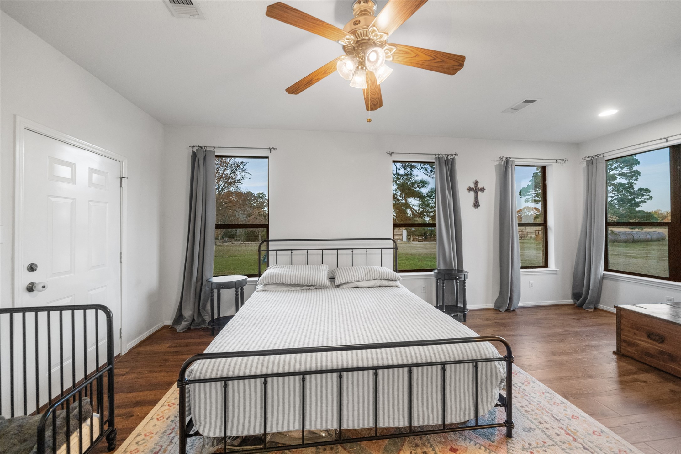 394 Farm To Market 230 Trinity, TX 75862 - Photo 17 of 34 a large bedroom with a bed and wooden floor