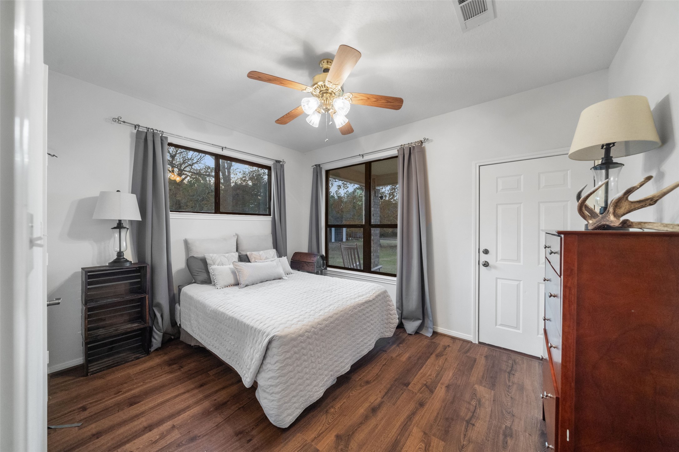 394 Farm To Market 230 Trinity, TX 75862 - Photo 21 of 34 a bedroom with a bed and a chandelier