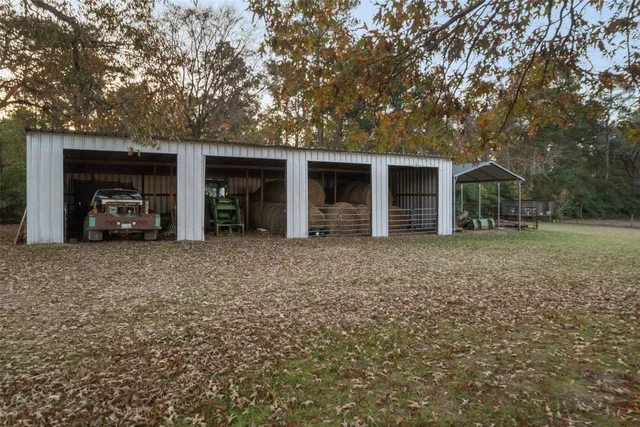 a view of a house with a yard and a tree