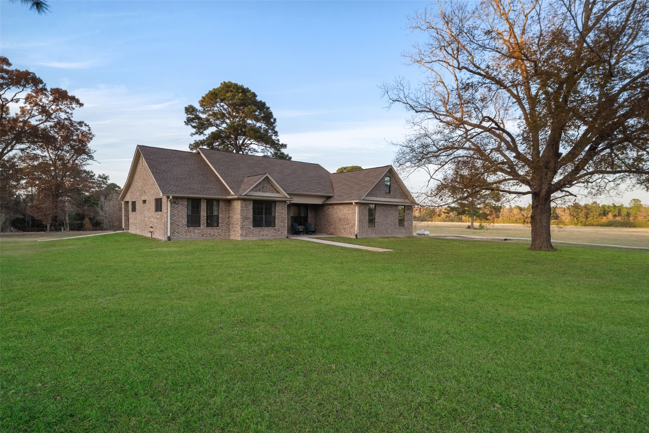 394 Farm To Market 230 Trinity, TX 75862 - Photo 3 of 34 a front view of house with yard and green space