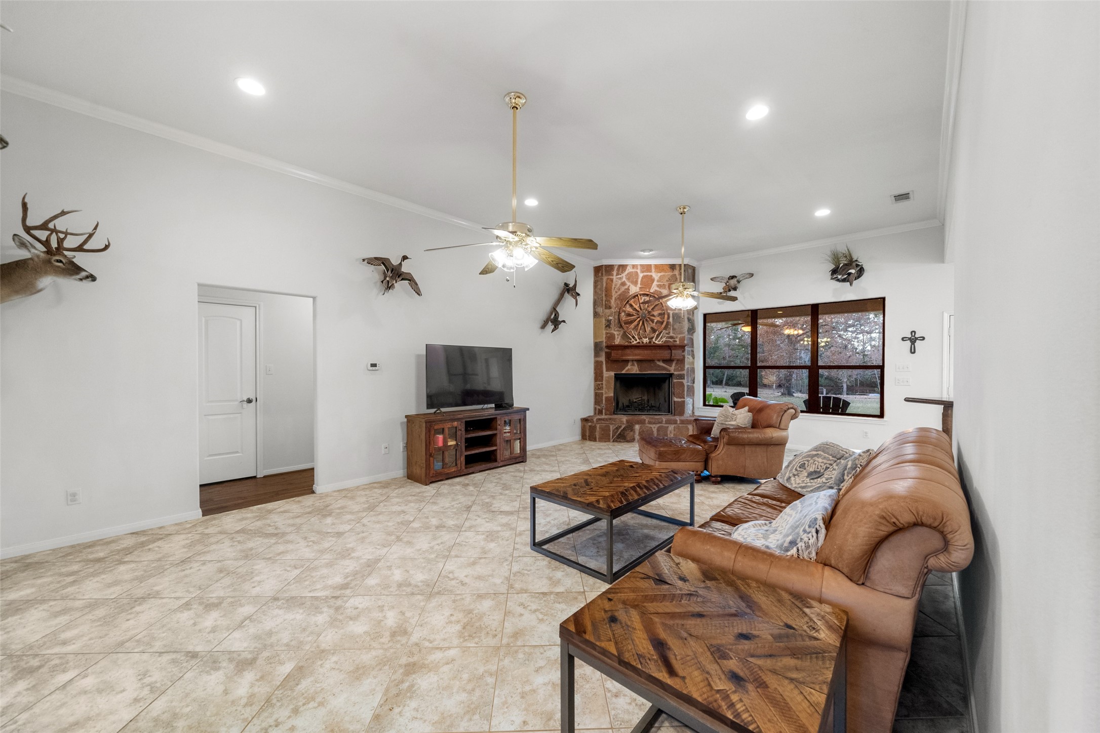 394 Farm To Market 230 Trinity, TX 75862 - Photo 8 of 34 a living room with furniture a chandelier and a flat screen tv