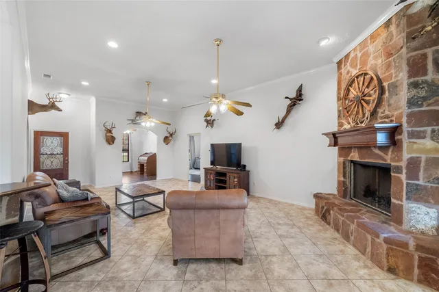a living room with fireplace furniture and a chandelier