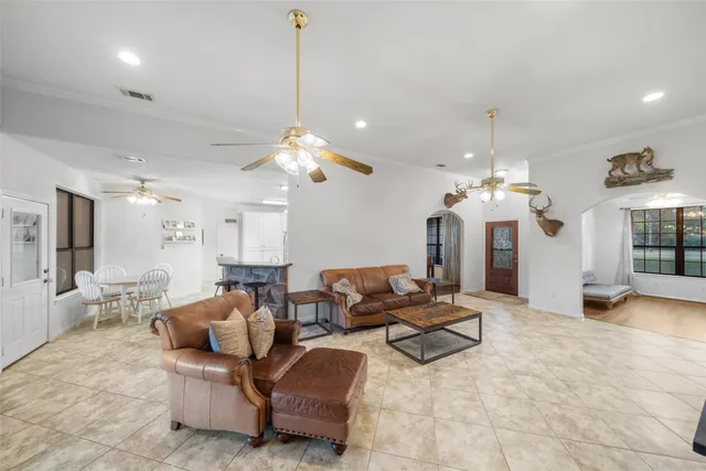 a kitchen with kitchen island a counter top space a sink cabinets and stainless steel appliances