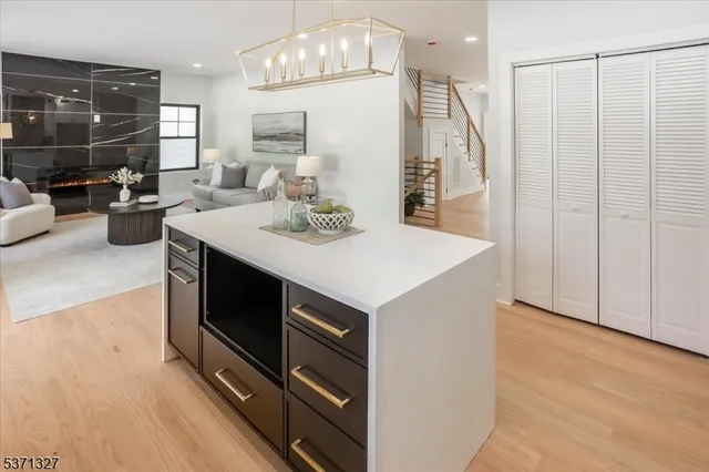 a kitchen with a sink a stove a refrigerator cabinets and dining table