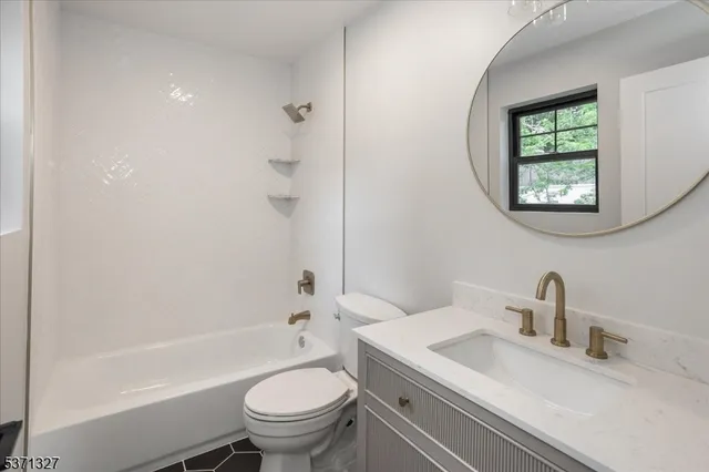 a bathroom with a sink and vanity