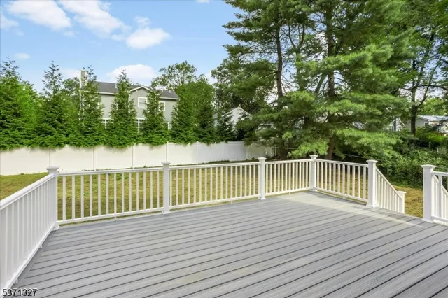 a view of a white house with a yard and plants