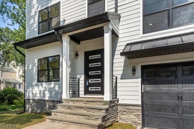 a front view of a house with garage