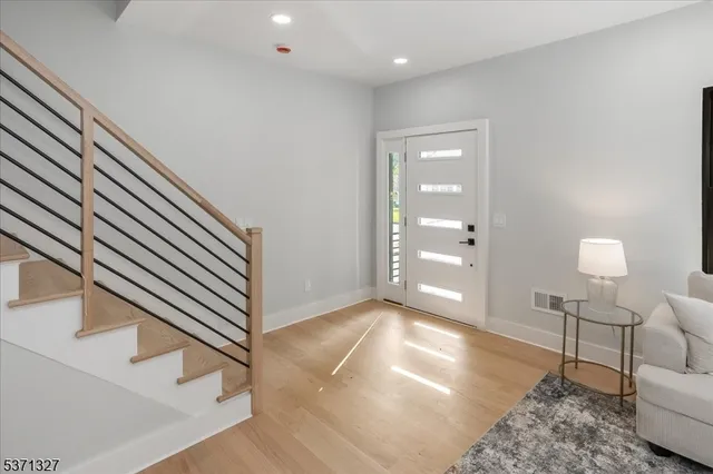 a view of a livingroom with furniture and stairs
