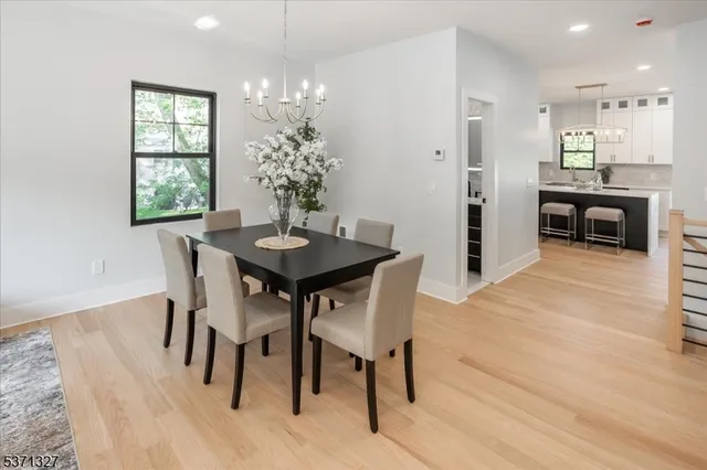 a view of a dining room with furniture wooden floor and chandelier