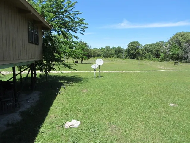 a view of a house with backyard and porch