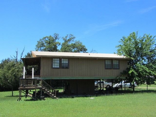 313 Jenkins Road Huntsville, TX 77320 - Photo 20 of 33 a view of house with yard and outdoor seating