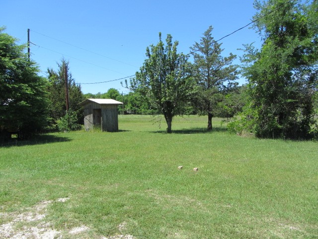 313 Jenkins Road Huntsville, TX 77320 - Photo 22 of 33 a view of a garden with a bench