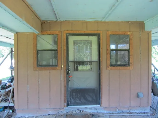a front view of house with a garden