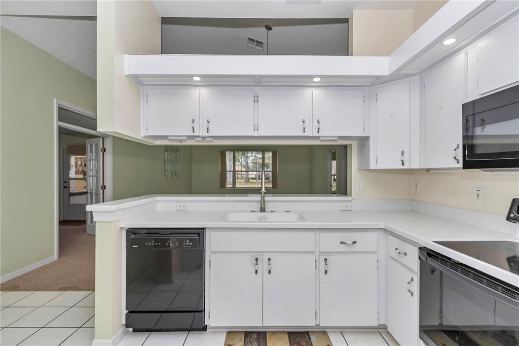 6793 Southwest 111th Loop Ocala, FL 34476 - Photo 24 of 47 Open kitchen looks into great room