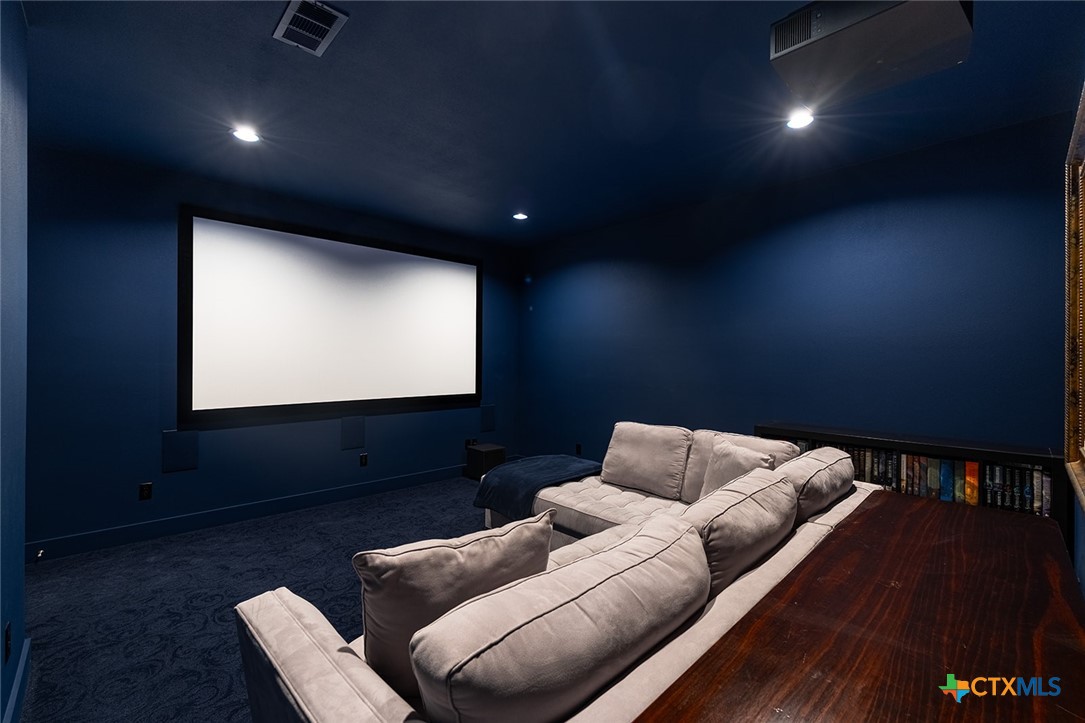 477 Willow Moon Ranch Road Crawford, TX 76638 - Photo 25 of 40 a projector room with furniture and a projector screen