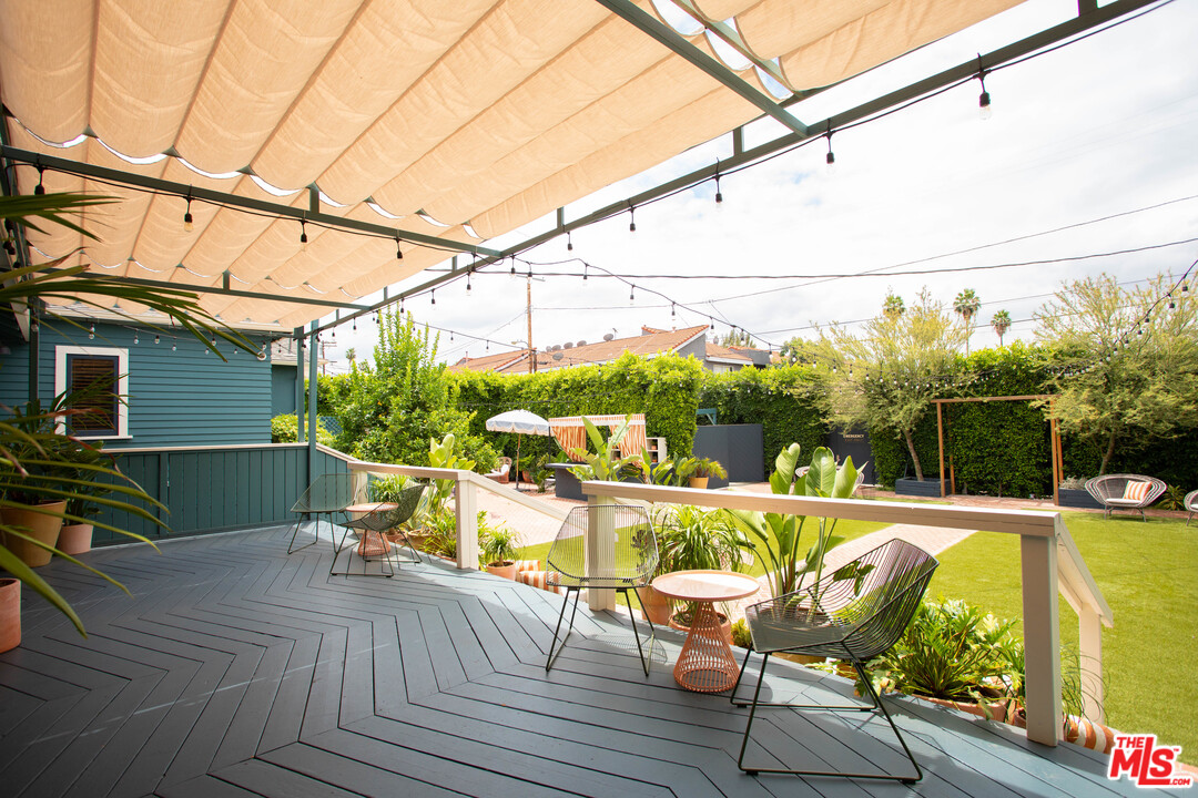 6408 Ruby Street Los Angeles, CA 90042 - Photo 28 of 36 a view of a balcony with chairs and wooden floor