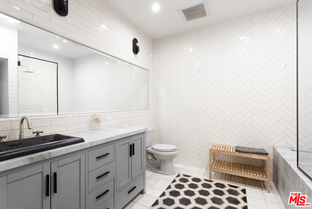 6408 Ruby Street Los Angeles, CA 90042 - Photo 36 of 36 a bathroom with a sink a toilet and a mirror