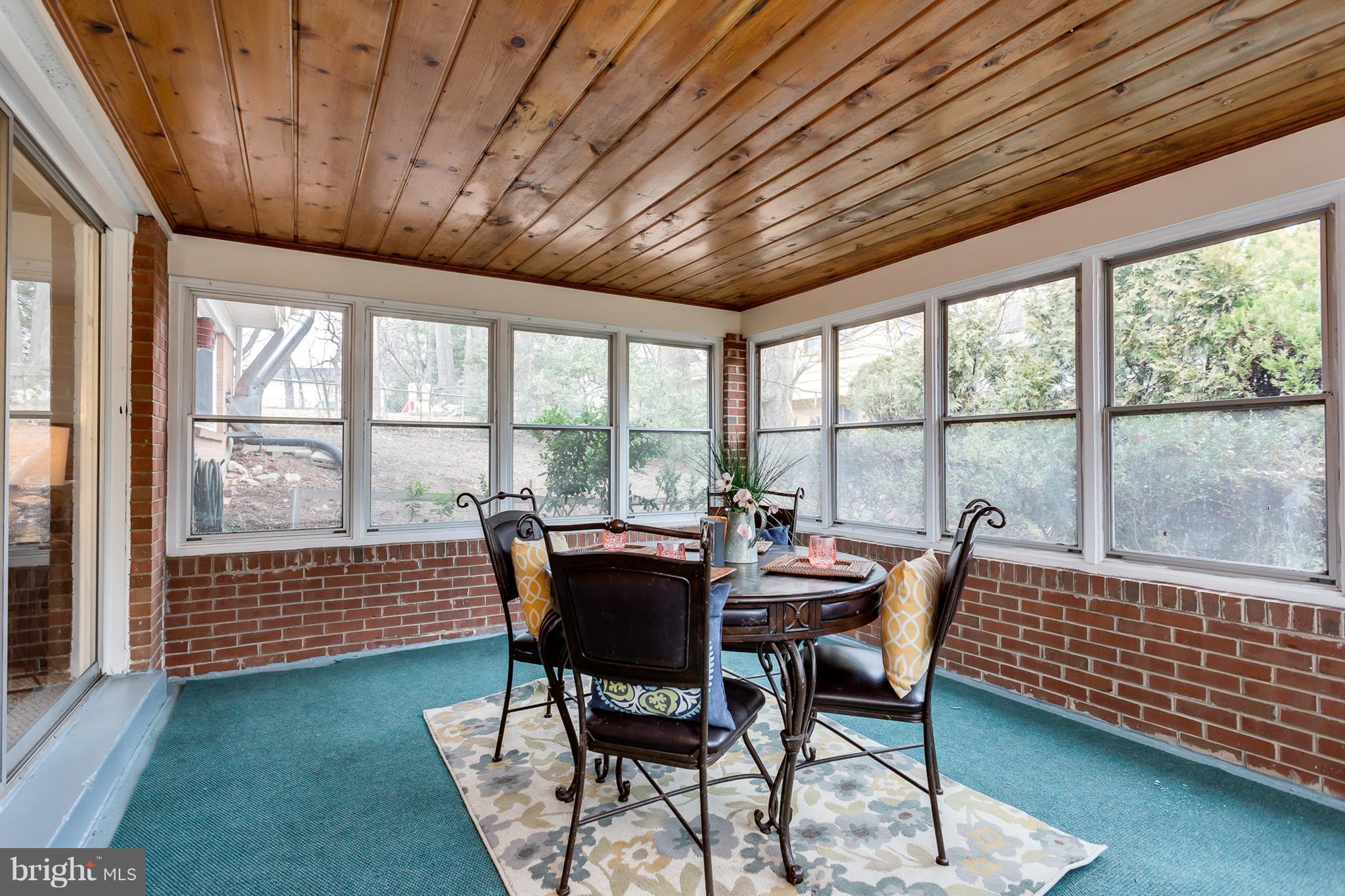 301 Irwin Street Silver Spring, MD 20901 - Photo 22 of 30 a dining room with furniture a rug and a large window