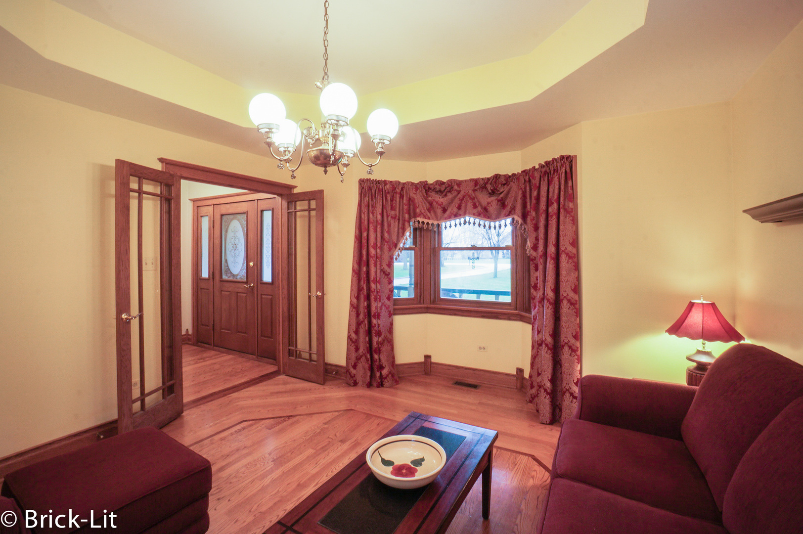 24102 South Schoolhouse Road Manhattan, IL 60442 - Photo 8 of 29 a living room with furniture and a chandelier