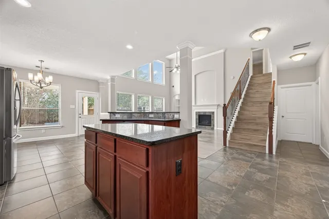 a kitchen with granite countertop a sink a stove and a wooden floor