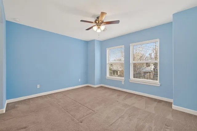 a view of a livingroom with a ceiling fan and window