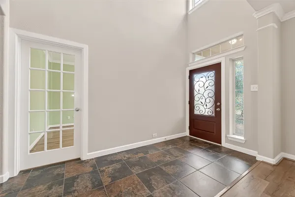 an empty room with windows and entrance