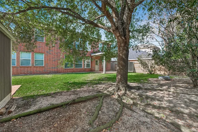 a view of a house with a tree in the yard