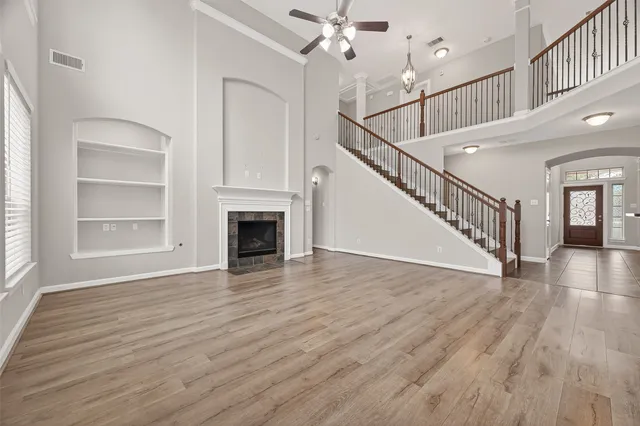 a view of a livingroom with wooden floor and staircase