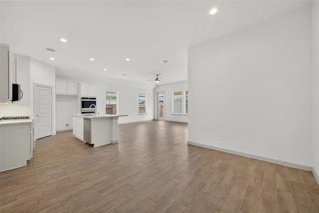 a view of kitchen with wooden floor and electronic appliances