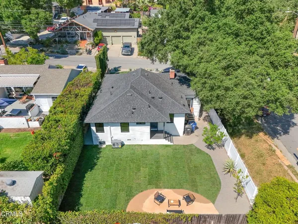 an aerial view of a house with a yard swimming pool a patio and yard