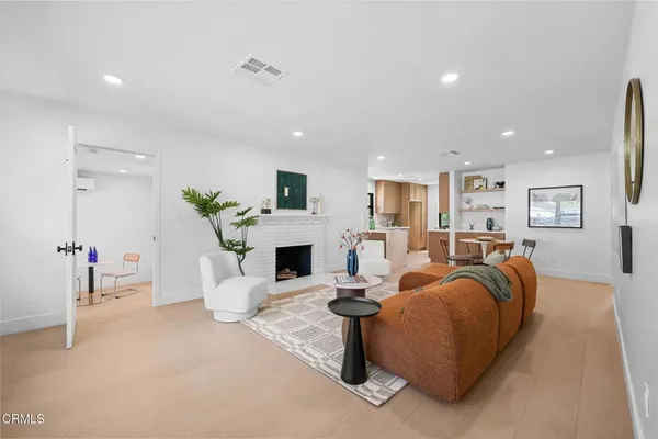 a living room with furniture a fireplace and a table