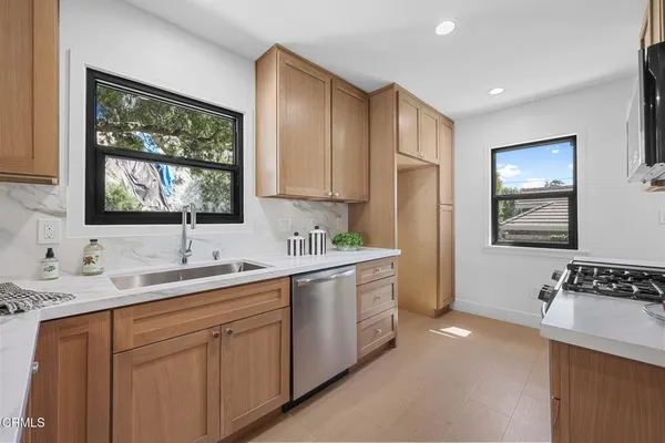 a kitchen with a sink cabinets and window