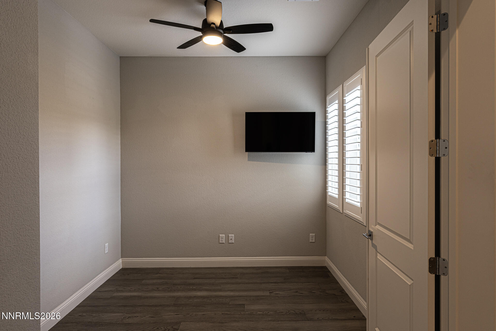 2109 Cast Iron Drive Reno, NV 89521 - Photo 10 of 35 an empty room with wooden floor fan and windows